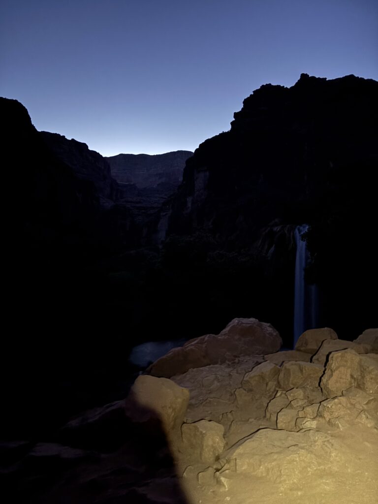 Havasu Falls glowing under starlight with headlamp