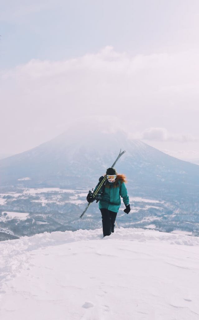 Woman in ski gear who was left behind her crew on a snowy mountain