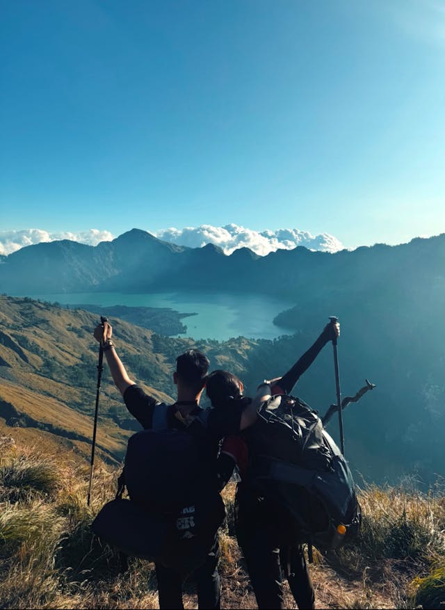 Man and woman walking through nature together, supporting each other