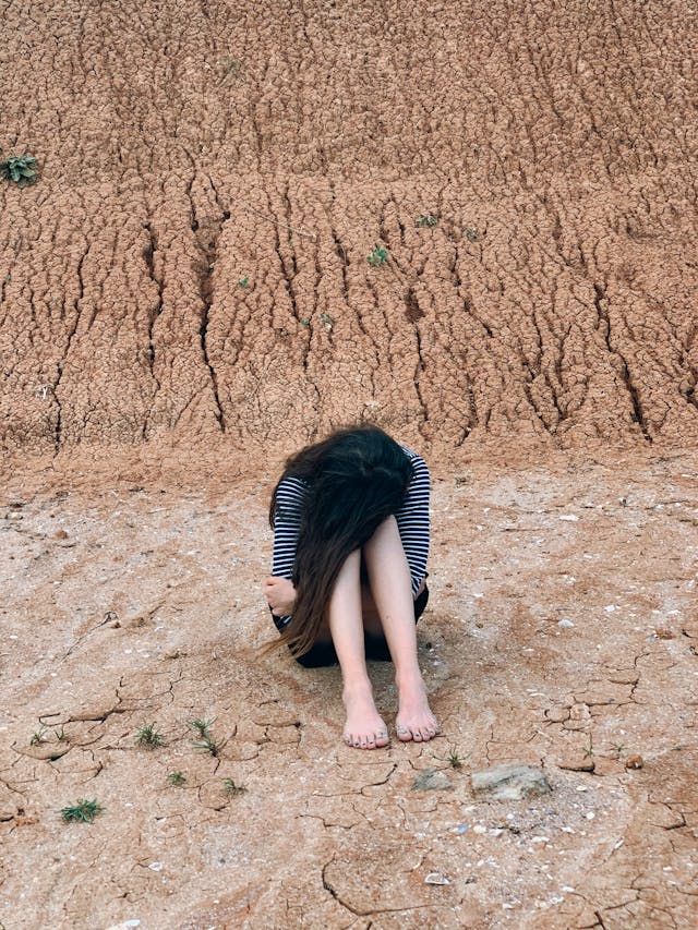 Girl with face buried and struggling