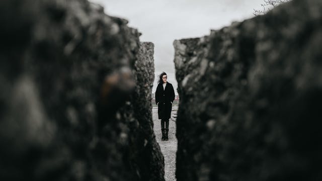 Mature woman looking through the cracks
