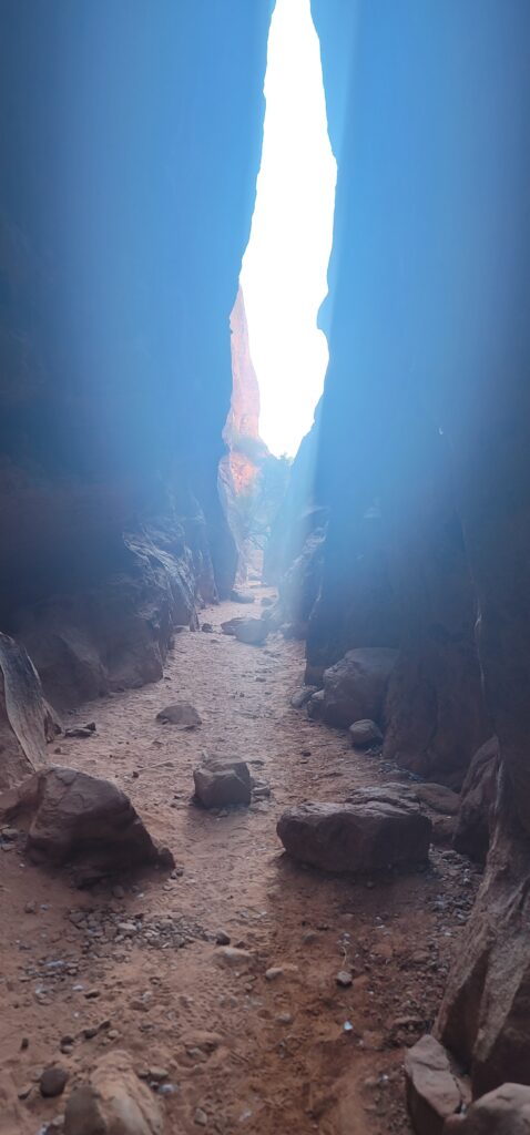 floor view of area between two rocks with boulders on the ground
