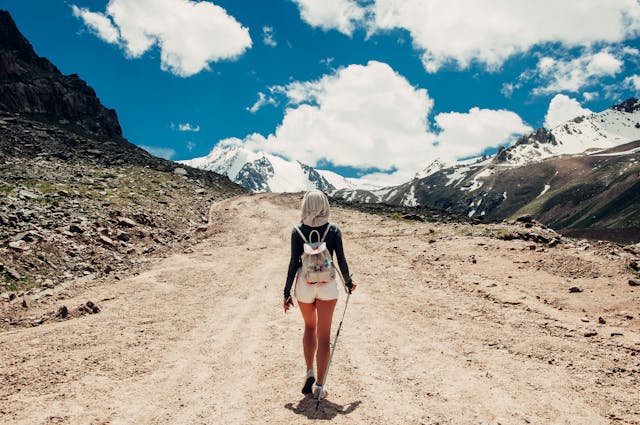 Woman in white shorts looking for Habitual Balance while traveling