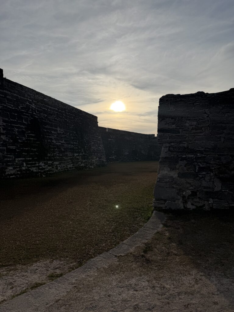 The sun setting over the fort
