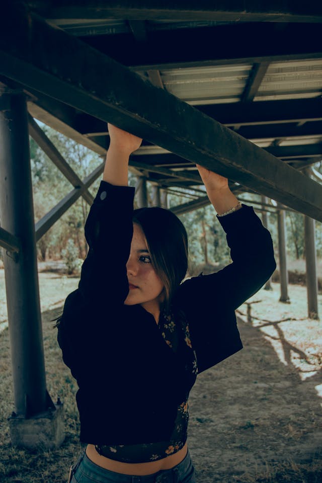 Young woman under deck holding on to rail