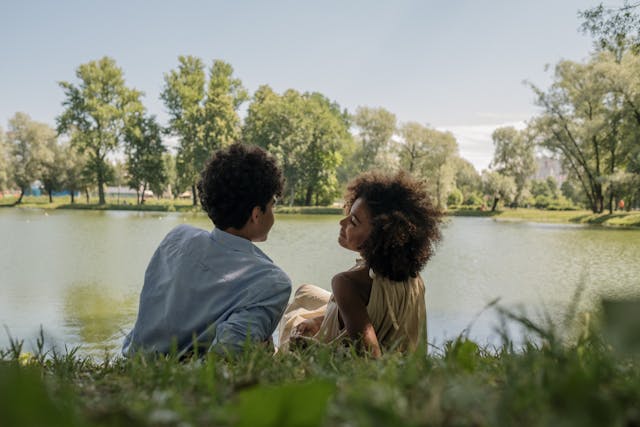 young couple discussing their future in front of a lake
