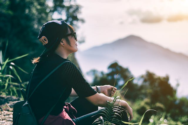 Girl in front of a mountain. 