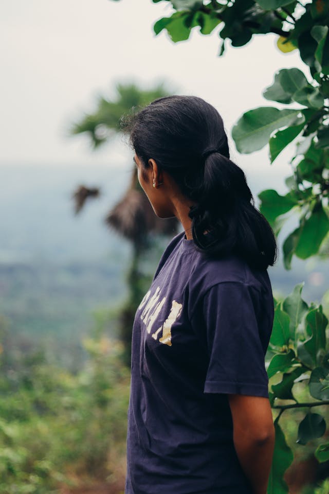 Woman looking off in the distance in a purple shirt thinking about habitual balance.