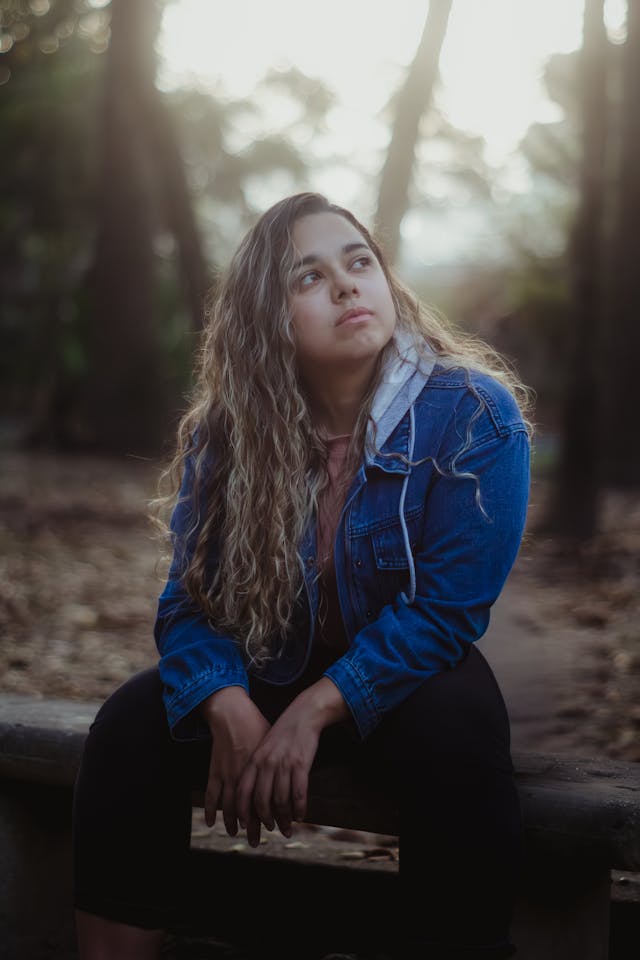 Girl sitting looking off in the distance