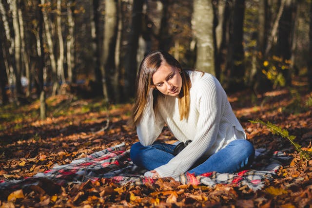 Girl sitting on a blanket thinking about life