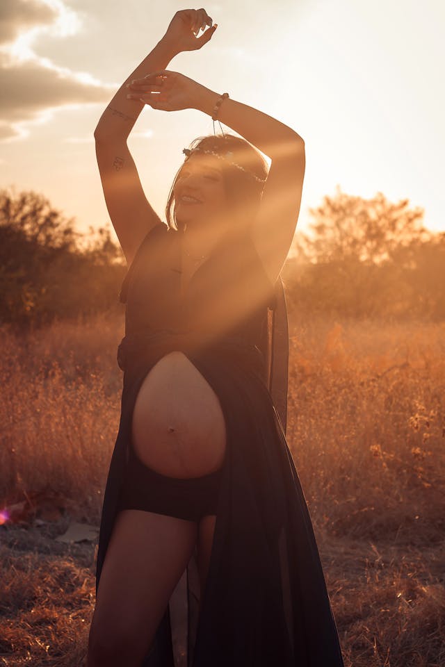 Pregnant mom dancing in the sunlight